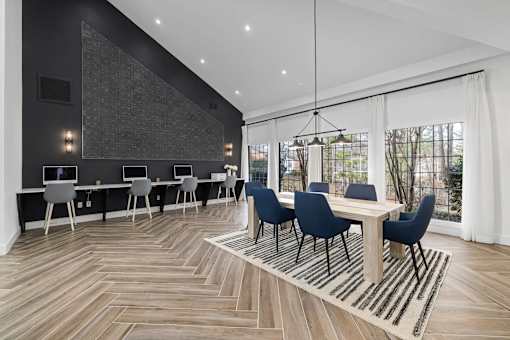 A modern dining room with a wooden table and chairs.