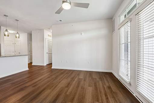 A room with wooden floors and a ceiling fan.