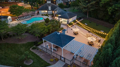 A backyard with a pool and a gazebo.
