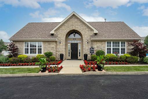 A house with a grey roof and a black door.