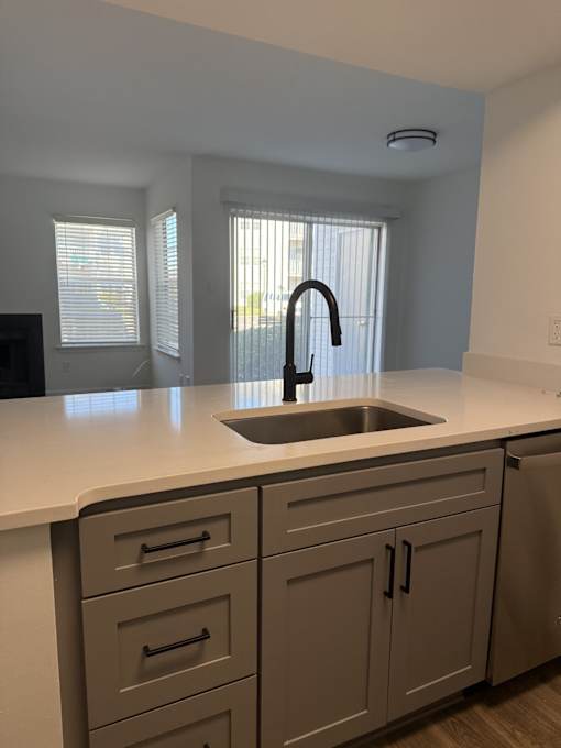 A kitchen with a sink and cabinets.