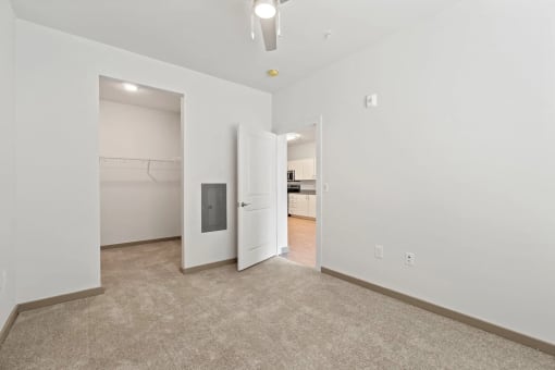 a living room with white walls and a door to a closetat Metropolis Apartments, Virginia, 23060