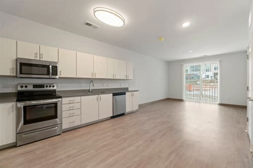an empty kitchen with white cabinets and stainless steel appliancesat Metropolis Apartments, Glen Allen, 23060