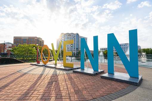 A large outdoor sign with the word LOVE in yellow and N in blue.
