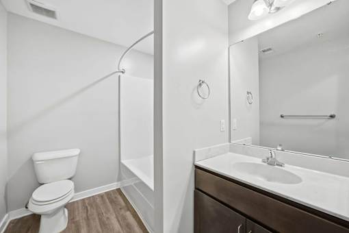 A white toilet is next to a sink in a bathroom.