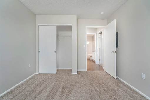 A room with a carpeted floor and white walls.