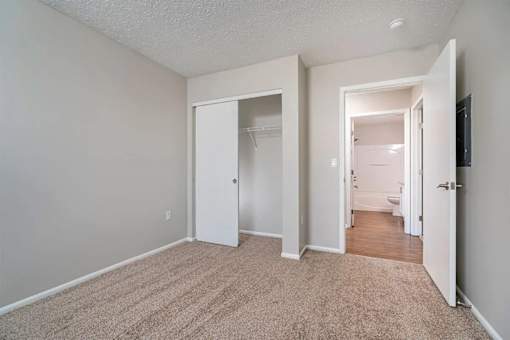 A room with carpeted floor and white walls.