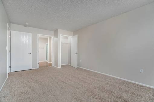 A room with carpeted floor and white walls.