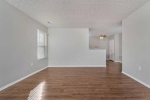 A room with wooden floors and white walls.