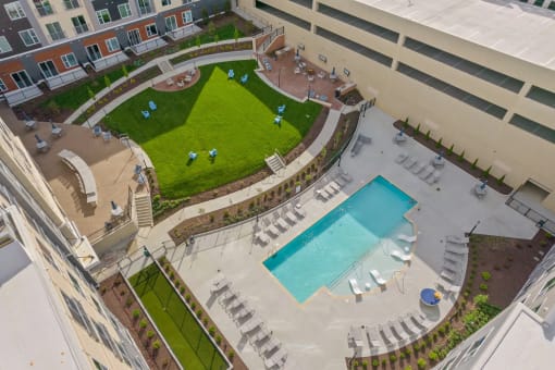 an aerial view of the pool and grassy area of an apartment buildingat Metropolis Apartments, Virginia