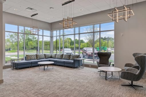 a large lobby with couches and chairs and large windowsat Metropolis Apartments, Glen Allen Virginia