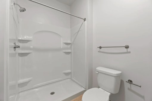 a white bathroom with a shower and a toiletat Metropolis Apartments, Virginia, 23060