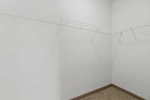 a room with white walls and a wire rack on the wall at Metropolis Apartments, Glen Allen, VA 23060