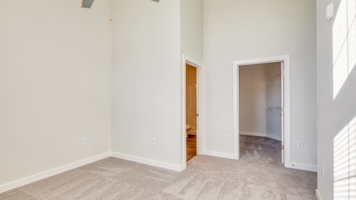 an empty bedroom with a door to a bathroom and a closet at The Bella at Westchester, Midlothian, 23113
