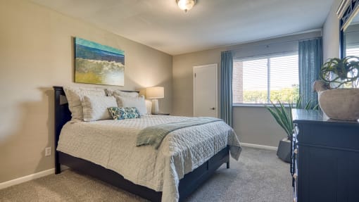 a bedroom with a large bed and a window