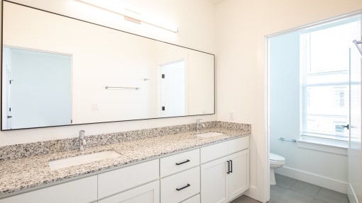 a bathroom with a large mirror and two sinks at Ainsworth, Richmond, VA