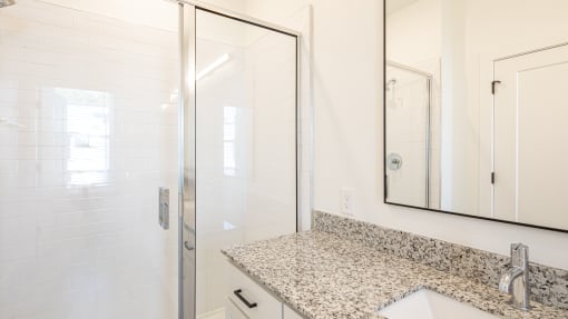a bathroom with a sink and a shower with a glass door at Ainsworth, Virginia