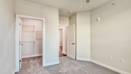 an empty room with a closet and a door to a laundry room at The Bella at Westchester, Midlothian, 23113