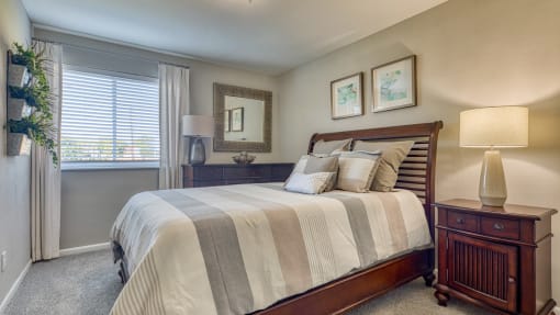 a bedroom with a large bed and a window