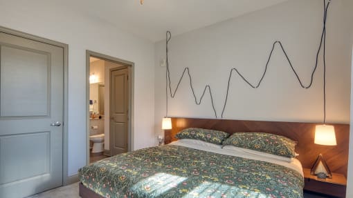 a bedroom with a bed and a line drawing on the wall above it