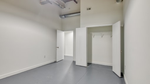 an empty room with white walls and white doors