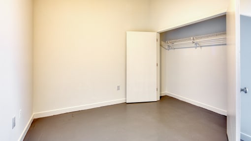 an empty room with a garage door and a closet
