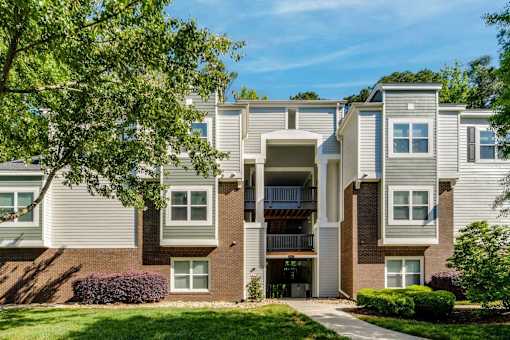 A modern apartment building with a mix of brick and siding exteriors.