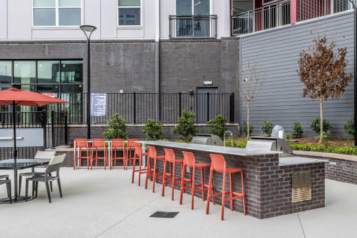 Expansive pool deck equipped with outdoor dining and grills at Centro at Pine Nash, Wilson, NC