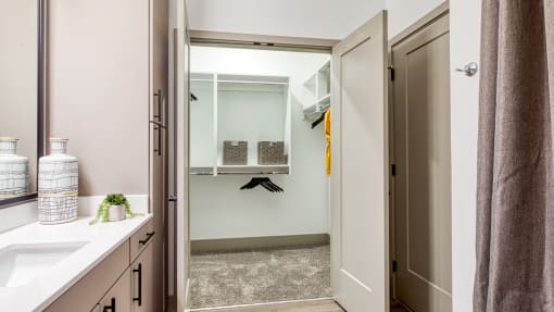 a bathroom with a shower and a sink and a mirror at Aura Stonebridge, Richmond Virginia