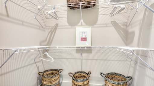Three baskets are hanging on a wire rack.
