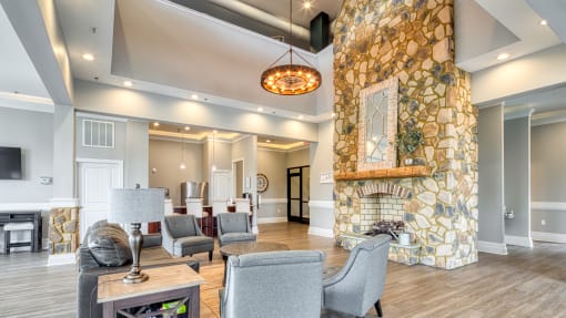 a large living room with a stone fireplace and furniture