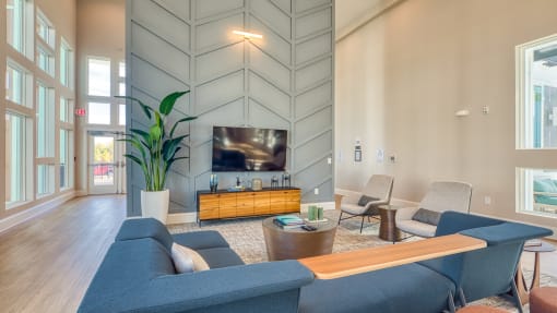 a living room with couches and a table and a televisionat The View at Blue Ridge Commons Apartments, Roanoke, 24017
