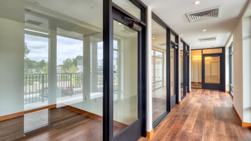 a hallway with glass doors and a view of a balcony at Ainsworth, Richmond, Virginia