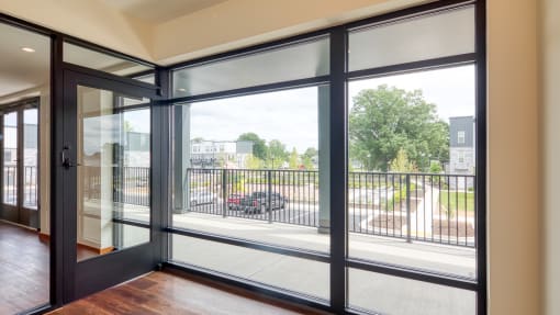 the view from the living room of a condo with glass doors and a balcony at Ainsworth, Virginia, 23228