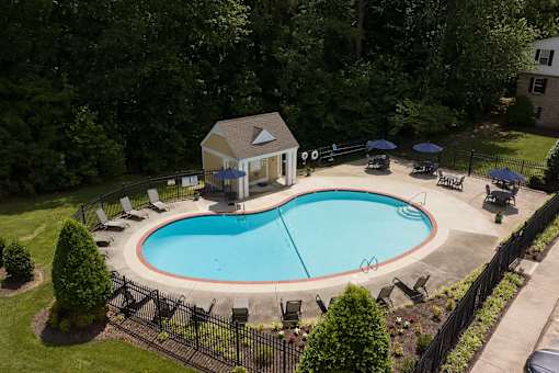 A small house with a pool in the backyard.