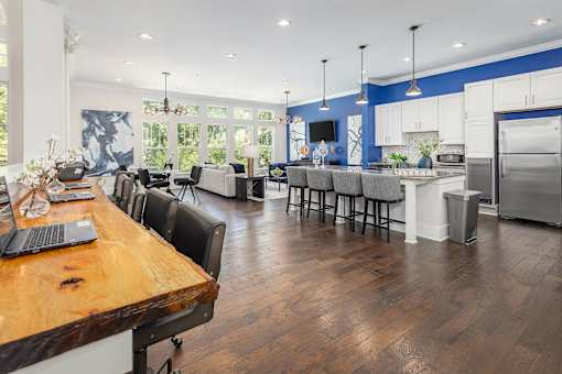 A modern kitchen with a wooden table and chairs.