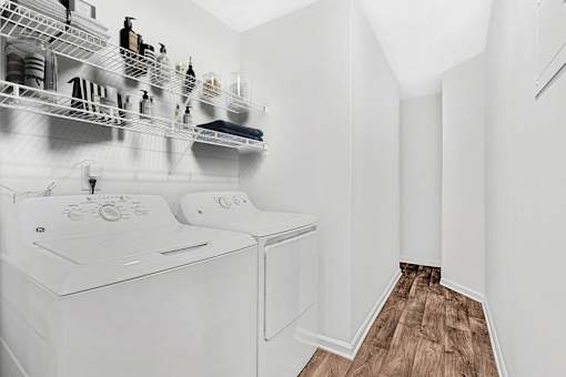 A white laundry room with a washer and dryer.