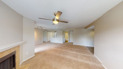 a living room with a fireplace and a ceiling fan