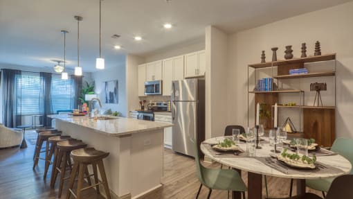 an open kitchen and dining area with a table and chairsat Blue Ridge Commons Apartments, Roanoke, Virginia