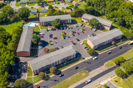 an aerial view of a parking lot and buildings