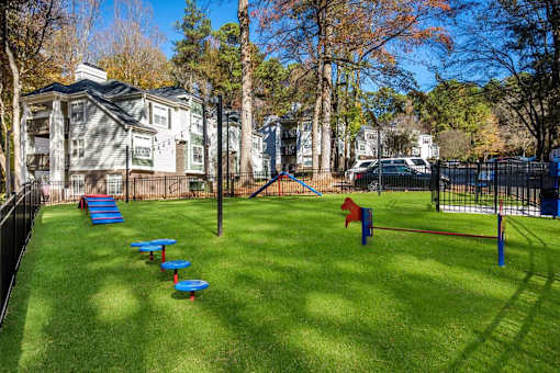 A playground with a slide and a red flag.