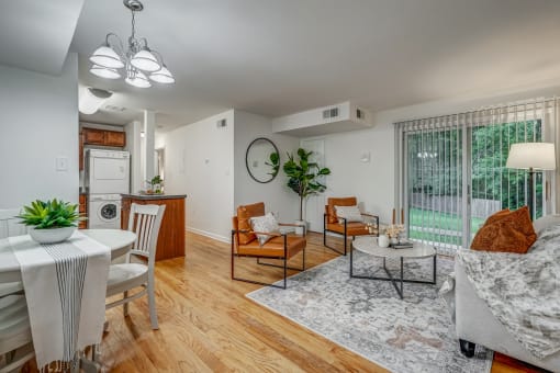 an open living room with a kitchen and a sliding glass door