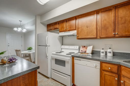 a kitchen with white appliances and wooden cabinets