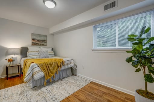a bedroom with a bed and a large window