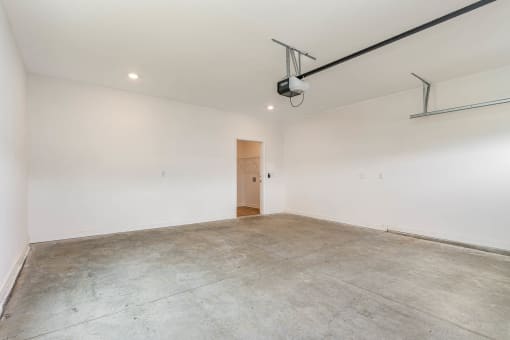 a white room with a concrete floor and a door