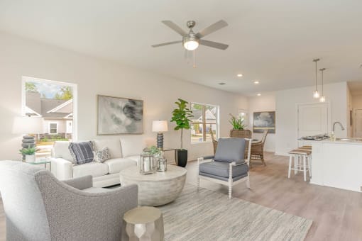 a white living room with a ceiling fan