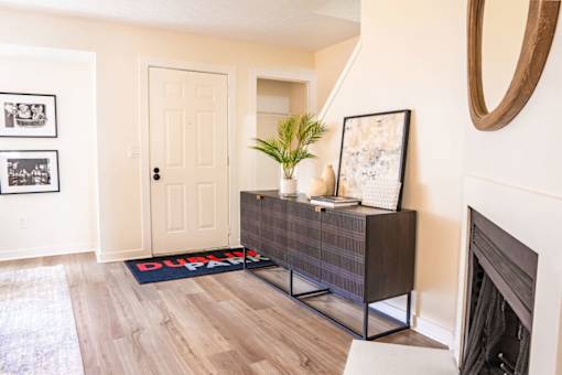 A room with a wooden floor and a white door.