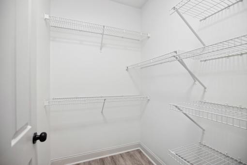 Empty white shelves in a room.