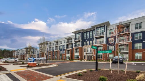 an exterior view of an apartment building on a city street at The Bella at Westchester, Virginia