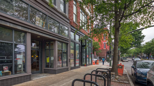 a city street with a bench in front of a building